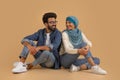 Romantic Young Muslim Couple Sitting On Floor And Looking At Each Other Royalty Free Stock Photo