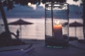 Romatic beach restaurant scene candles sunset blurred background Royalty Free Stock Photo