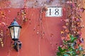 Rome architecture detail with street lamp and house number