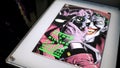 Perspective view of the famous cover of the comic Batman: The Killing Joke, in a display case at The Art of the Brick DC Super He