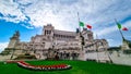 Rome - Italian national flag with scenic view on the front facade of Victor Emmanuel II monument on Piazza Venezia in Rome Royalty Free Stock Photo