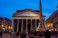 Night view of many people in front of the famous Pantheon building in Rome.