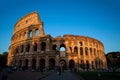 Tourists visiting the famous Colosseum under the beautiful light of the golden hour in Rome Royalty Free Stock Photo