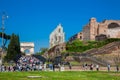 Tourists visiting the Ruins of the Temple of Venus and Roma located on the Velian Hill and Arch of