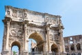 ROME, Italy: The Arch of Constantine in Rome with Colosseum in background. Arco di Costantino Royalty Free Stock Photo