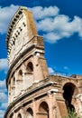Rome, Italy. Arches archictecture of Colosseum exterior with blue sky background and clouds Royalty Free Stock Photo