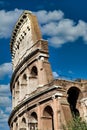 Rome, Italy. Arches archictecture of Colosseum exterior with blue sky background and clouds Royalty Free Stock Photo