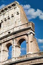 Rome, Italy. Arches archictecture of Colosseum exterior with blue sky background and clouds Royalty Free Stock Photo