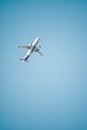 View of an Alitalia passenger airplane flying over Rome, Italy with a blue sky Royalty Free Stock Photo