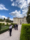 Rome, Italy - 09 august 2023: Girl photographer photographs the groom with his friends in the garden of an old villa