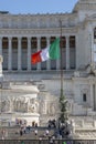 Italian flag on the background of Vittoriano - a monument in honor of the King of Italy Victor