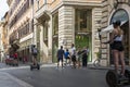 People on Segways ride along a street in the center of Rome