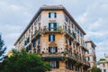 Rome, Italy - A beautifully architectured apartment in downtown Rome during a cloudy afternoon with the classical green windows