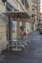 Rome, Italy, 25.12.2019: cafe tables on the street of the city along the road, tables with umbrellas near the cafe Royalty Free Stock Photo