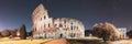 Rome, Italy. Colosseum Also Known As Flavian Amphitheatre In Evening Or Night Time. Bold Bright Blue Night Starry Sky Royalty Free Stock Photo