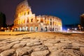 Rome, Italy. Colosseum Also Known As Flavian Amphitheatre In Night. Calmness Night Time. Bright Blue Night Starry Sky