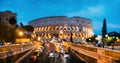 Rome, Italy. Colosseum Also Known As Flavian Amphitheatre. Traffic In Rome Near Famous World Landmark In Evening Time Royalty Free Stock Photo