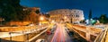 Rome, Italy. Colosseum Also Known As Flavian Amphitheatre. Traffic In Rome Near Famous World Landmark In Evening Time. Royalty Free Stock Photo