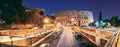 Rome, Italy. Colosseum Also Known As Flavian Amphitheatre. Traffic In Rome Near Famous World Landmark In Evening Time Royalty Free Stock Photo