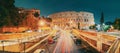 Rome, Italy. Colosseum Also Known As Flavian Amphitheatre. Traffic In Rome Near Famous World Landmark In Evening Time. Royalty Free Stock Photo