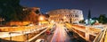 Rome, Italy. Colosseum Also Known As Flavian Amphitheatre. Traffic In Rome Near Famous World Landmark UNESCO In Evening Royalty Free Stock Photo