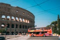 Rome, Italy. Colosseum. Red Hop On Hop Off Touristic Bus For Sightseeing In Street Near Flavian Amphitheatre. Famous Royalty Free Stock Photo