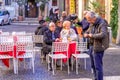 Rome, Italy - December 17, 2019: Elderly senior Italian couple in street cafe in historic city