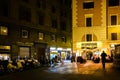 Night life in Rome. People enjoying the evening at the restaurant and many scooters parked on the street Royalty Free Stock Photo