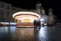 Rotating carousel with wooden horses. Circle effect of lights.