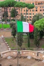 Rome, Italy - December 17, 2019: Rome skyline and river Tibre as seen from Castel Sant`Angelo with Italian flag