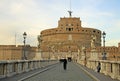 ROME, ITALY - DECEMBER 20, 2012: Young ecclesiastic and other people on the bridge of Castel Sant'Angelo in Rome, Italy Royalty Free Stock Photo