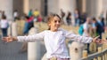 Rome, Italy - 29.10.2019: happy beautiful girl with outstretched arms in the Vatican Square