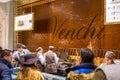 Rome, Italy - January 11, 2019: People in the Venchi sweet shop with flowing chocolate on the wall, Rome. Venchi is an Italian