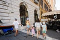 Rome, Italy - July 27, 2022: Family tourists walk in street, Rome, Italy