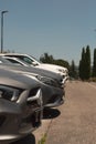 Line of modern Mercedes-Benz vehicles parked outside a Mercedes Benz car dealership in Rome.