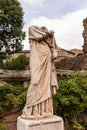 Ancient headless statue under blue sky