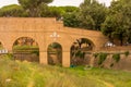 Rome, Italy - 23 June 2018: Arch made of red bricks over a grass landscape in Rome, Italy used to transport water