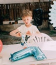 Rome Italy. June-21. 2020. boy birthday in the garden. parents help to unpack gifts. Concept of happy birthday, celebration - Royalty Free Stock Photo