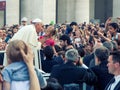 Pope Francis in the crowd in St. Peter`s in Vatican City in Rome, Italy. The Pope greets the faithful and meets them in the squar