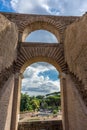 Rome, Italy - 23 June 2018: Ruins of the roman forum viewed through the gated arch of the passage at the entrance of the Roman Royalty Free Stock Photo