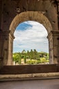 Rome, Italy - 23 June 2018: Ruins of the roman forum viewed through the gated arch of the passage at the entrance of the Roman Royalty Free Stock Photo