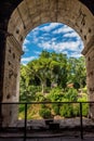 Rome, Italy - 23 June 2018: Ruins of the roman forum viewed through the gated arch of the passage at the entrance of the Roman Royalty Free Stock Photo