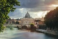Tiber River and St. Peter`s Dome at sunset in the Vatican City in Rome in Italy. Cavour bridge and Castle of the Holy Angel