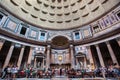 Tourists admire the altar and famous domed ceiling inside the Pantheon building in Rome Royalty Free Stock Photo