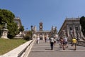 Tourists on Michelangelo stairs to Piazza del Campidoglio on the top of Capitoline Hill Royalty Free Stock Photo