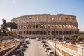 ROME, ITALY - 10 MARCH 2018: ancient Colosseum ruins on sunny day with cars parked on street Royalty Free Stock Photo