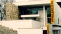 Entrance of the Ara Pacis museum seen from the street with poster of the current exhibition dedicated to the well-known Italian d