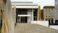 Entrance of the Ara Pacis museum seen from the street with poster of the current exhibition dedicated to the well-known Italian di