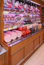 Gastronomy department with processed meats. Grocery shop shelves with products inside a grocery store market in Rome in Italy Royalty Free Stock Photo