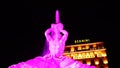 Night long exposition of the triton of the homonymous fountain lit with pink headlights